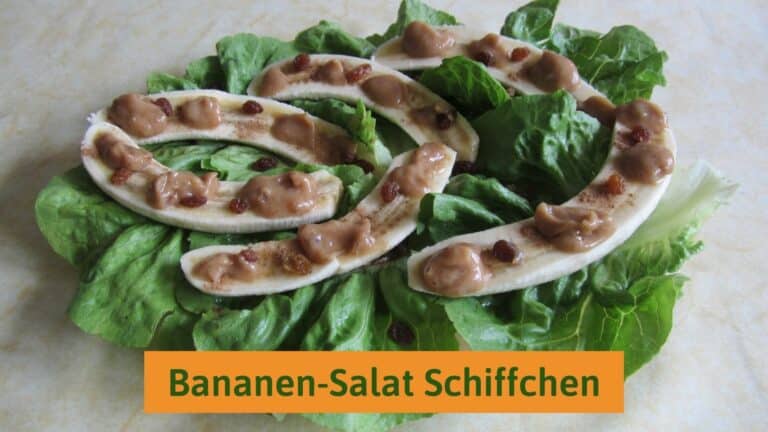 Bananas smeared with date sauce on lettuce leaves