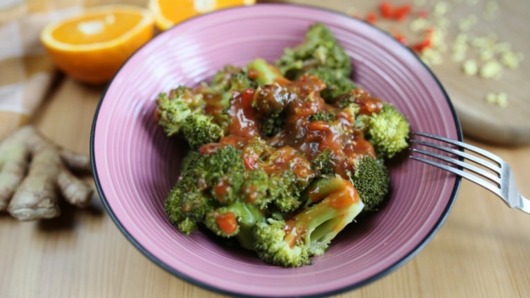 Plate of sweet and spicy broccoli on table