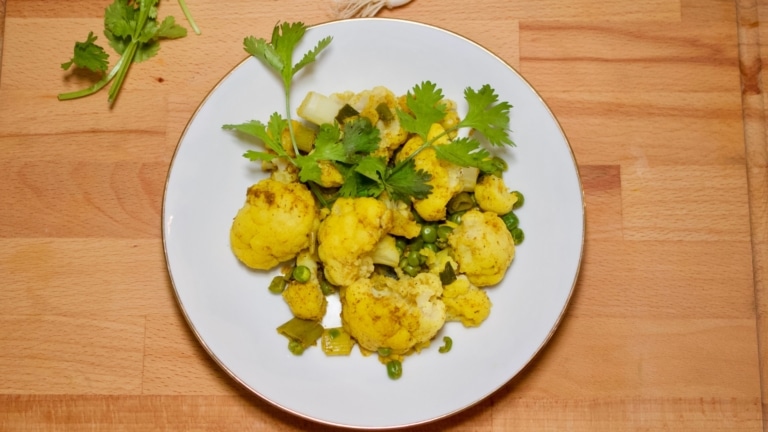Plate of curried cauliflower and peas